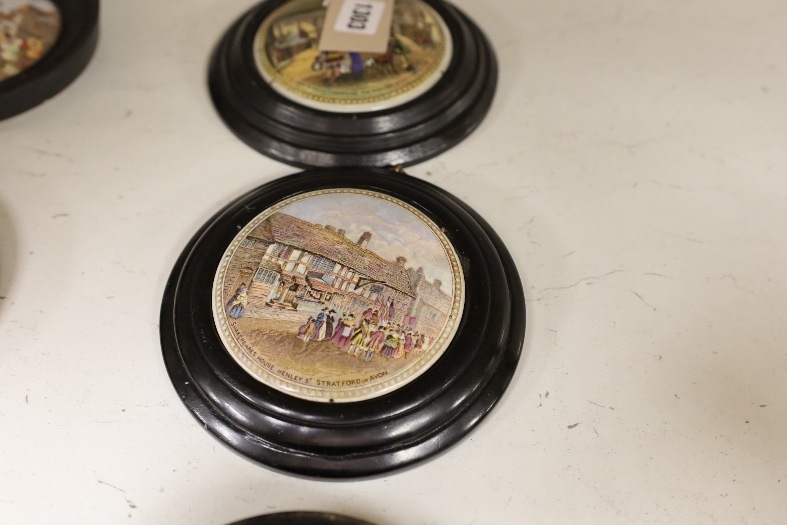 Ten 19th century framed ceramic pot lids